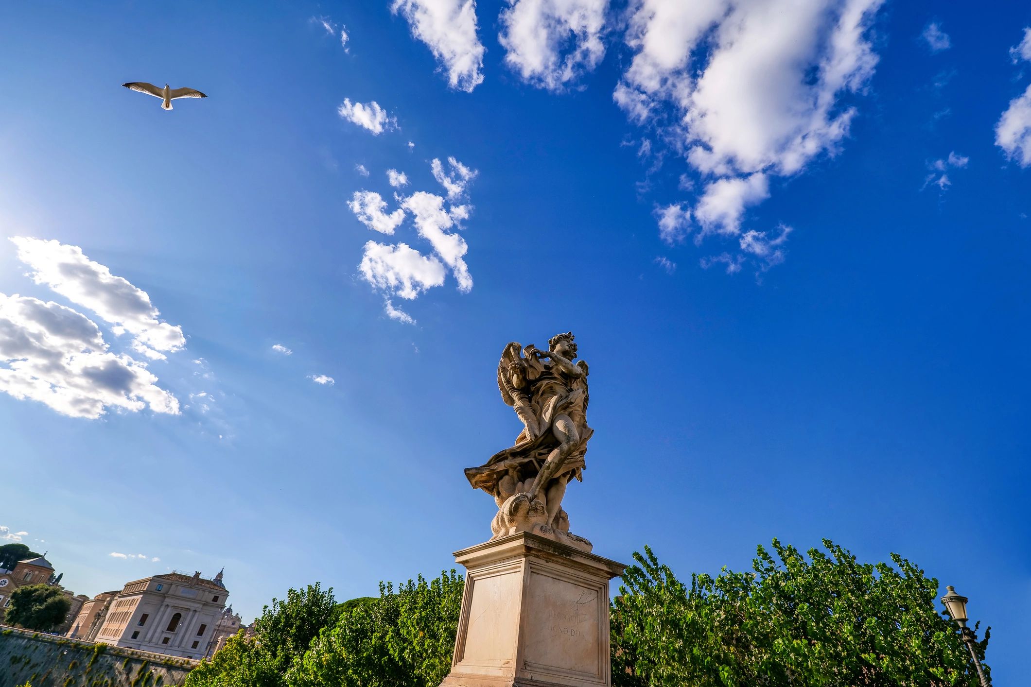 Classical angel statue against a vivid blue sky
