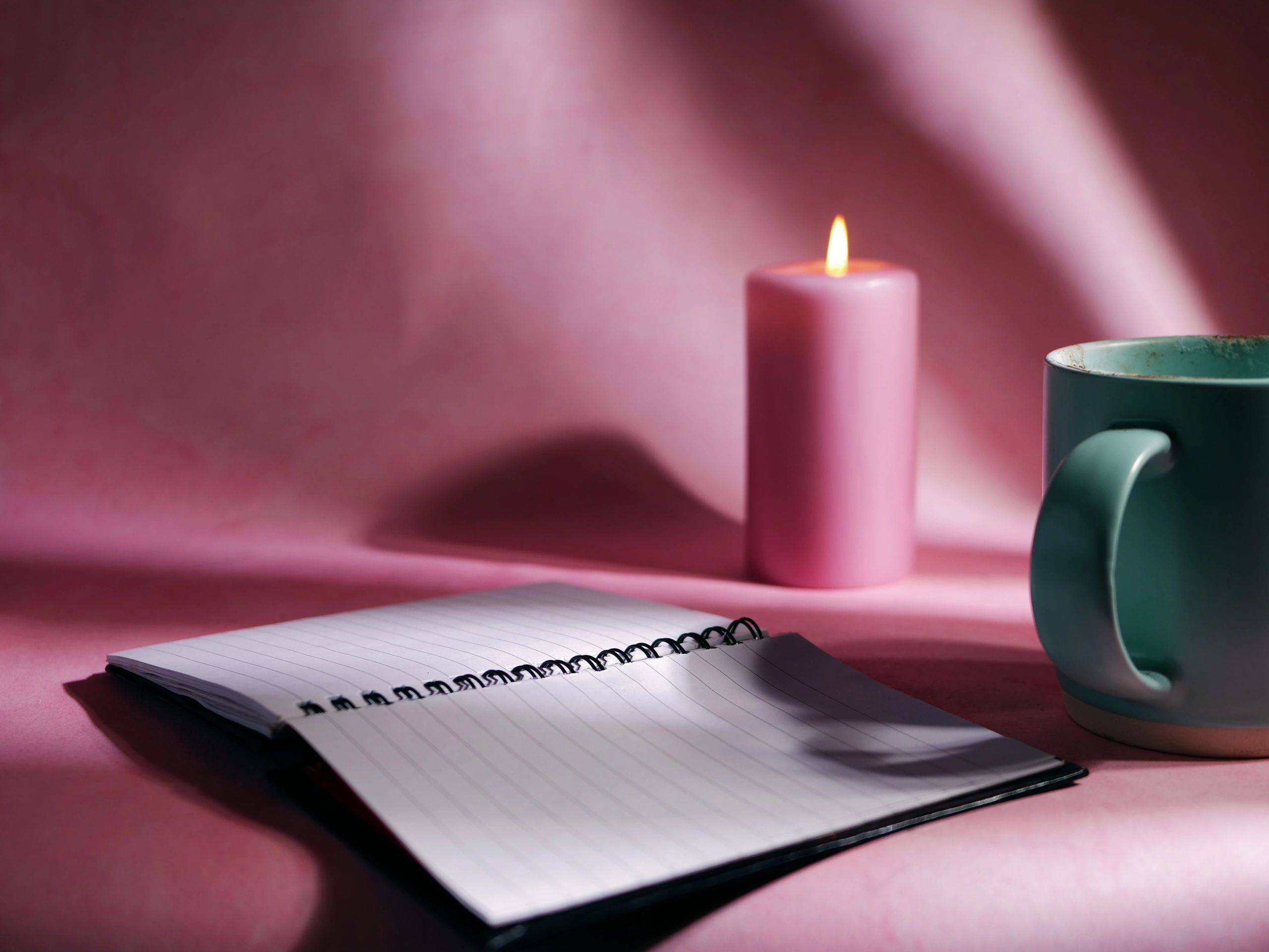 Journal with warm drink for quiet reflection