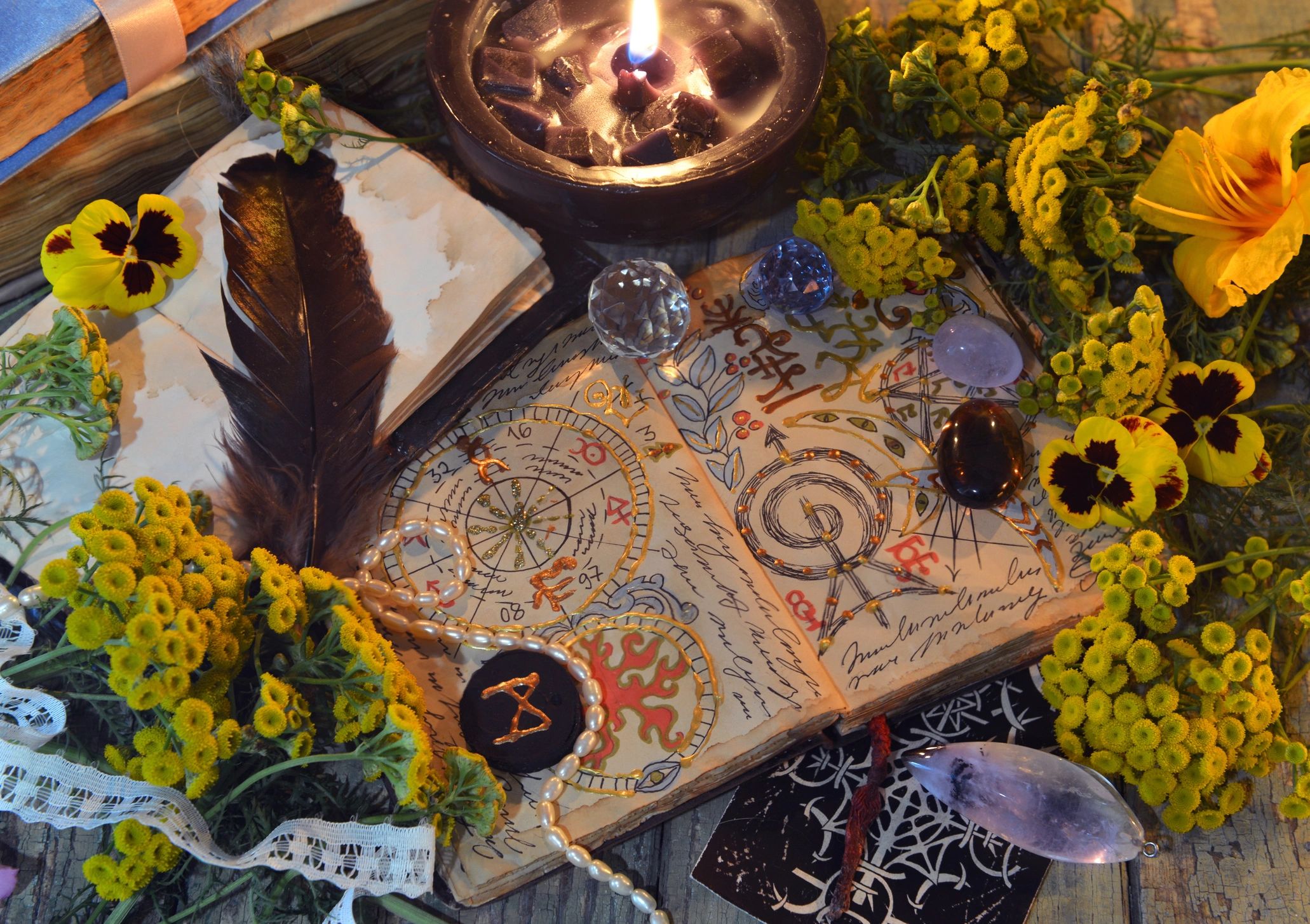 Mystic still life with book, tarot card, crystals, and candles on a table