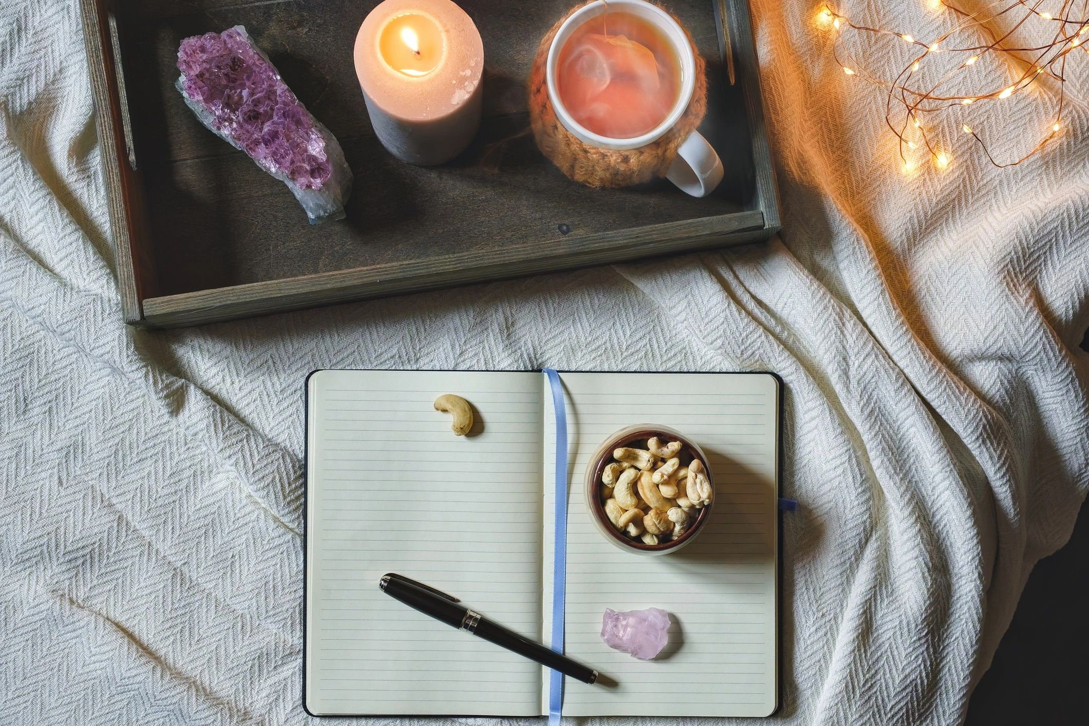 Open journal with candle and crystal for dream reflection